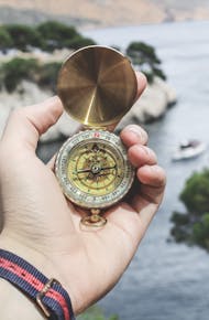 Person Holding Compass